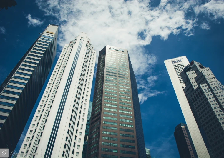 tall skyscrs stand in front of a clear blue sky