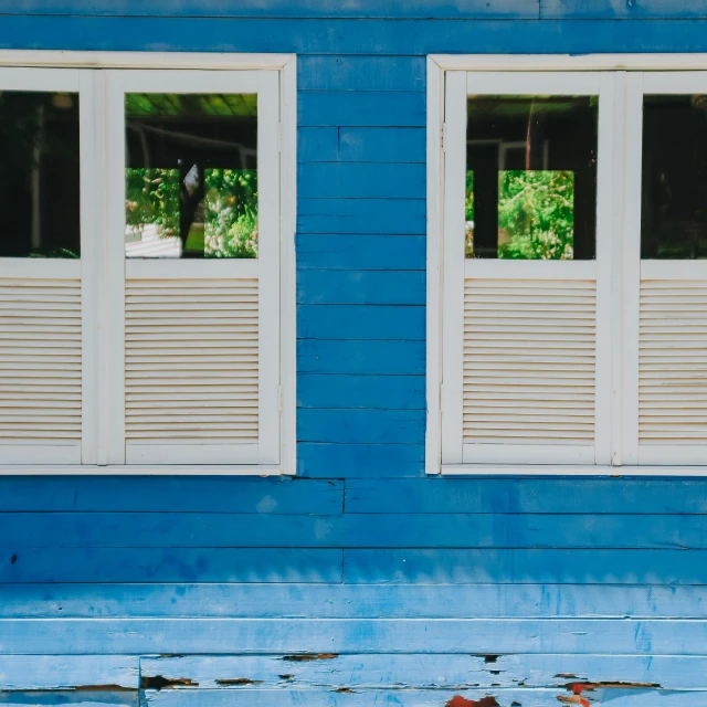 window covered bench next to a blue building