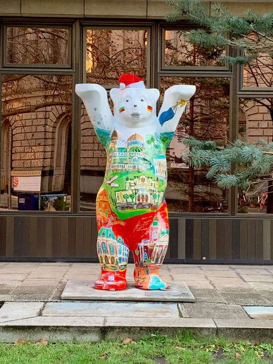 a statue of a bear with buildings in the window