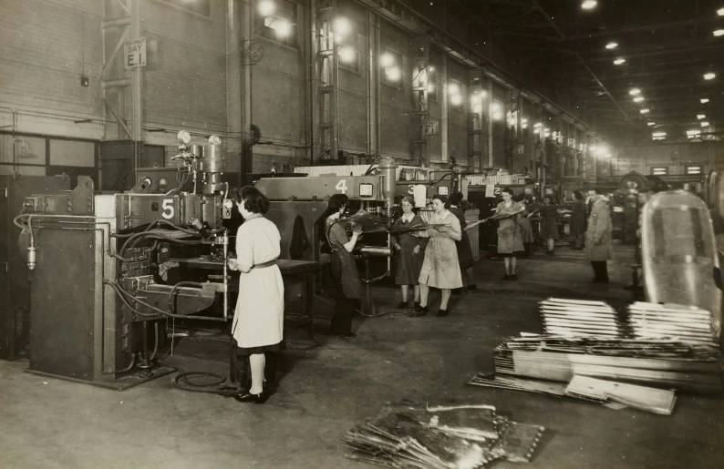 a factory with workers working with machines and lots of boxes