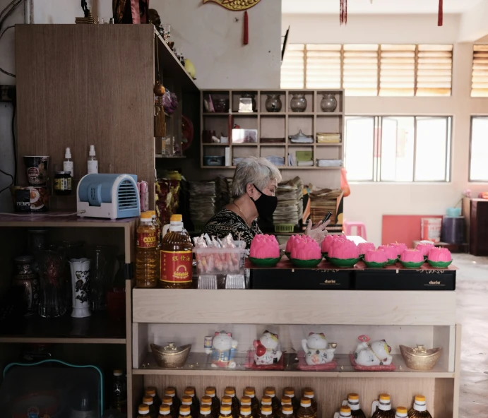 a woman talks on her phone at the shop