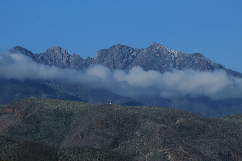 there is a plane flying over the mountains