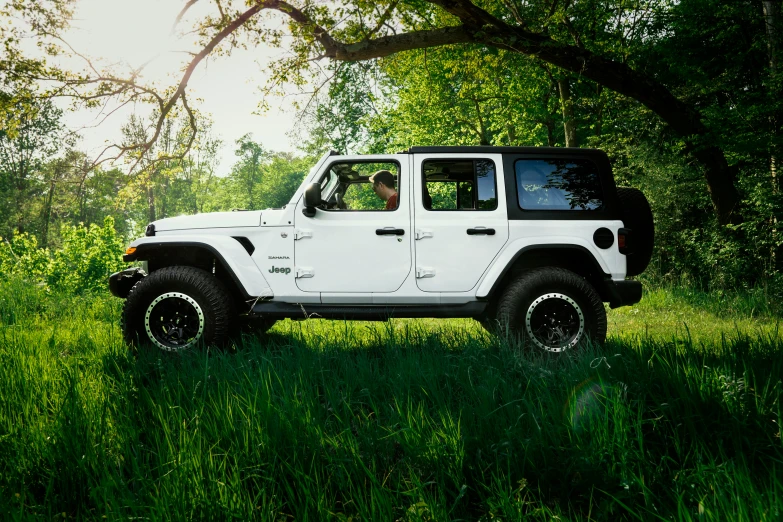 the jeep is white in color and has a black top