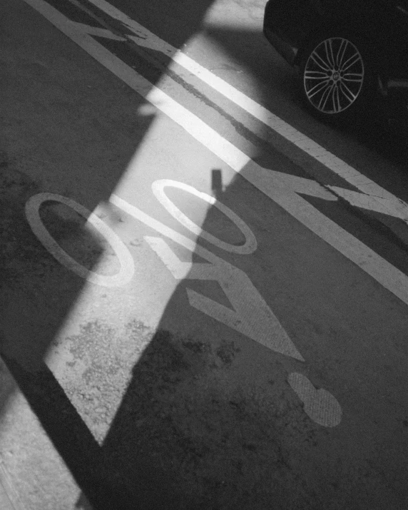 shadow of car parked at cross walk on street