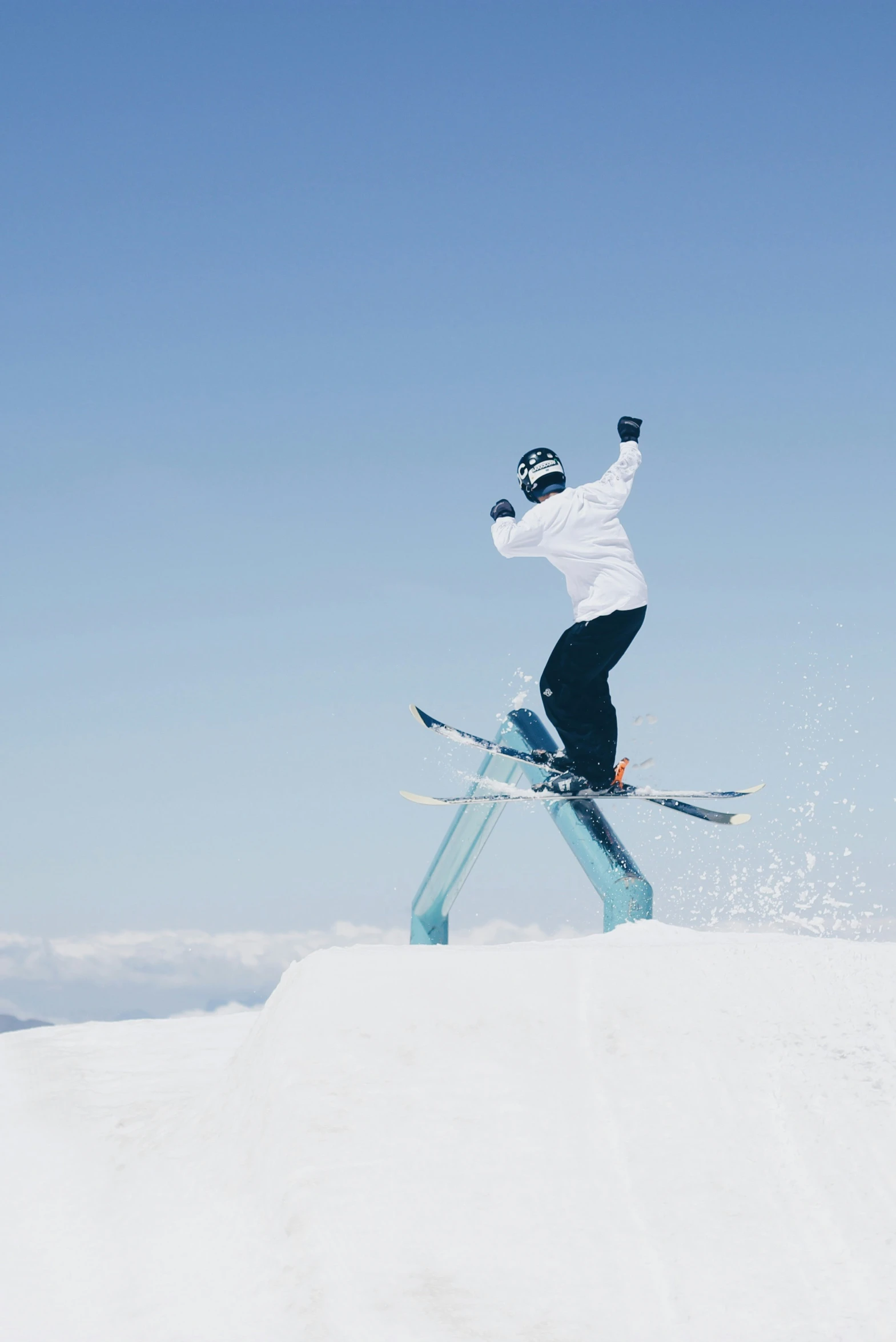 a skier performs a jump on a clear day