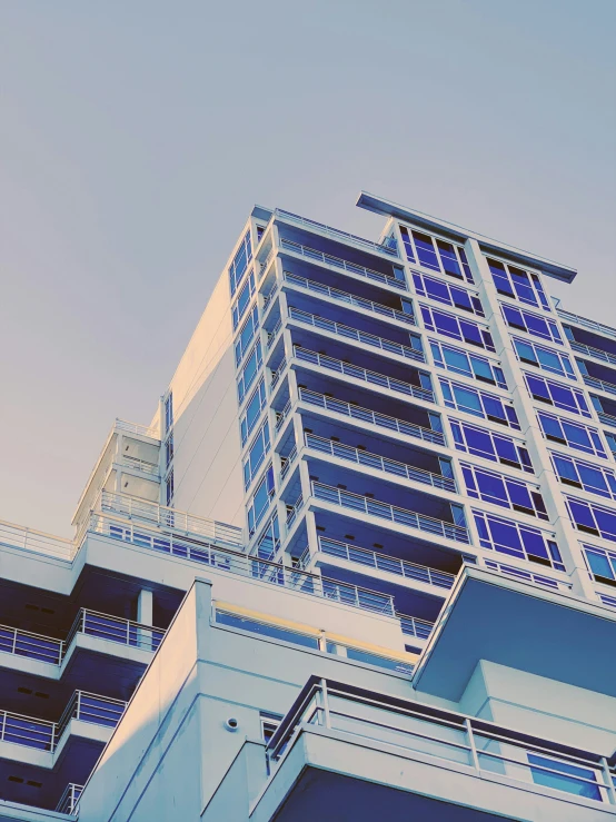 a large building with multiple floors is against the blue sky