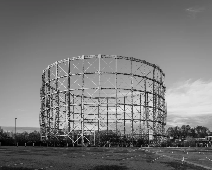 a huge building in a large field with buildings around it