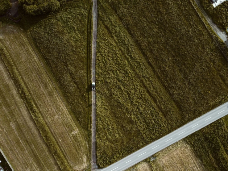 a very large open field next to a road