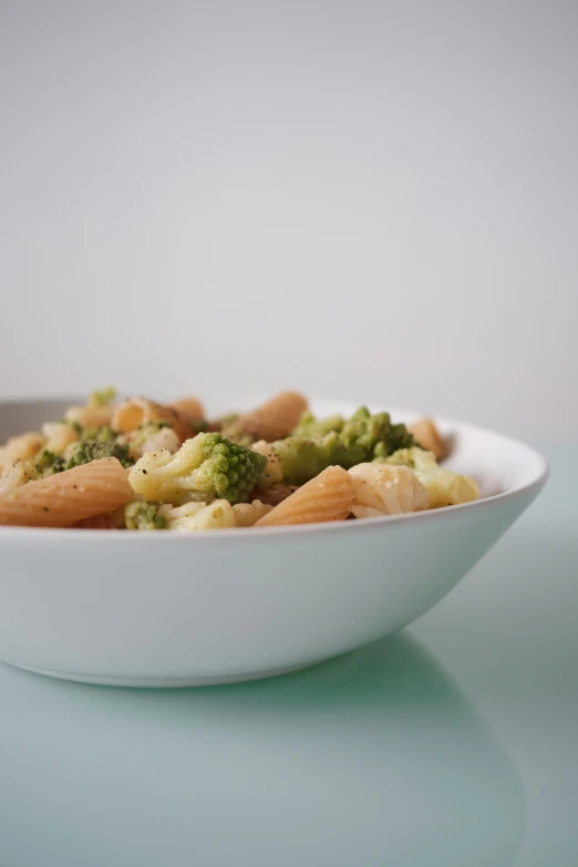 a pasta dish served with broccoli, and peanuts