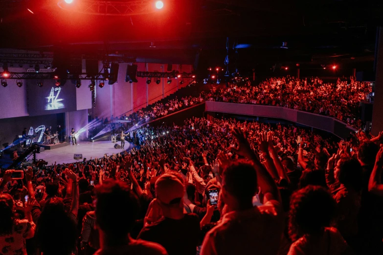 people are gathered to watch someone perform at a concert