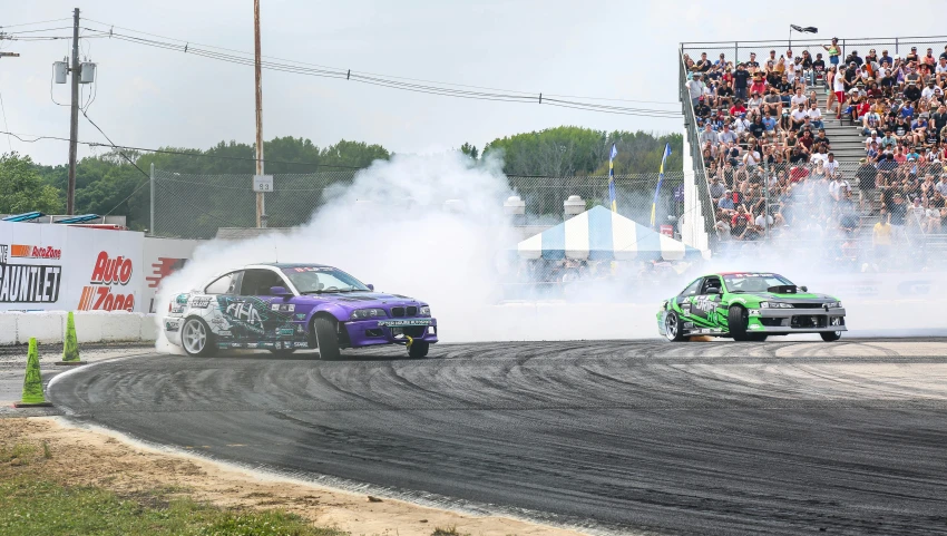 two cars that are racing on a track