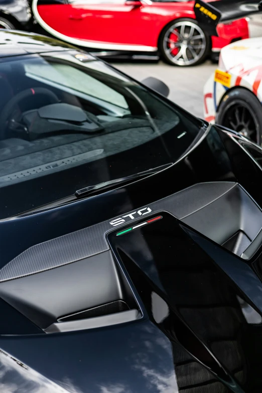 black supercars parked at a very busy road