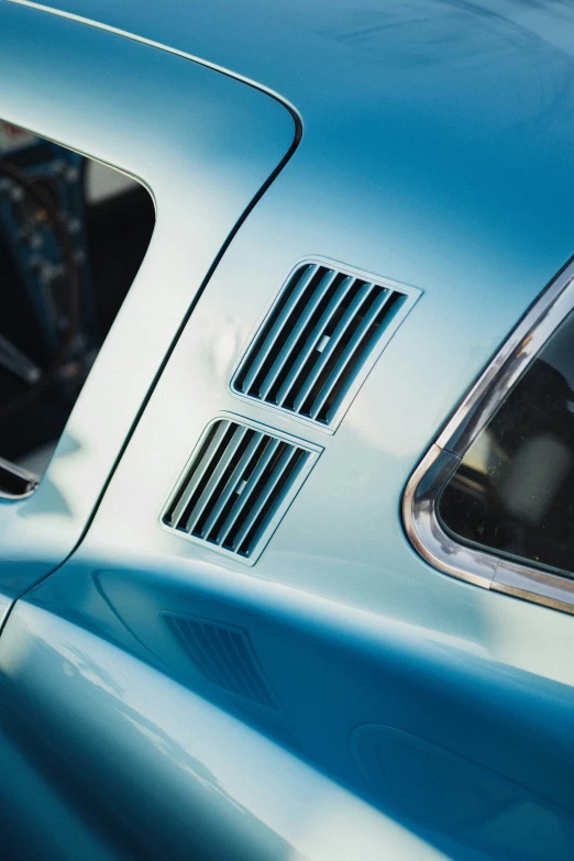 the windows and grills of a vintage blue car