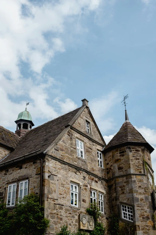 an old building with a green top and sky