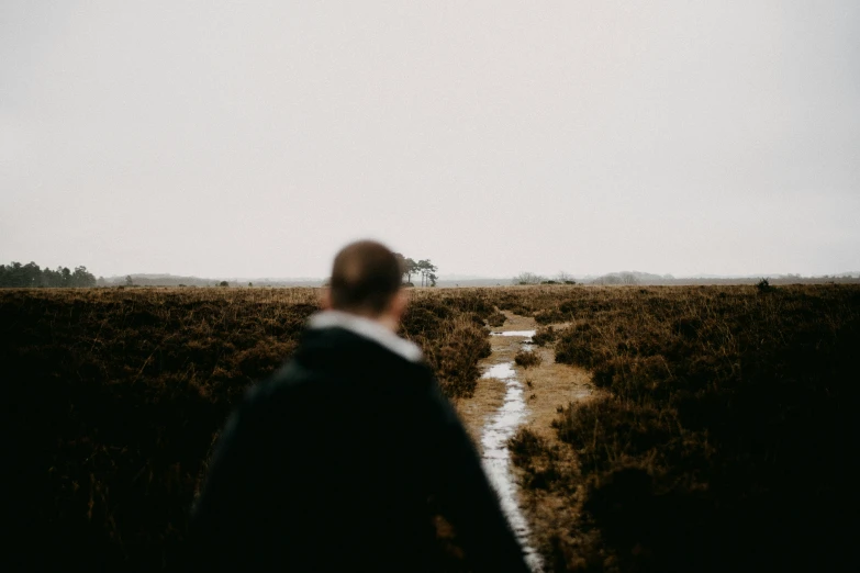 there is a man that is walking in the rain