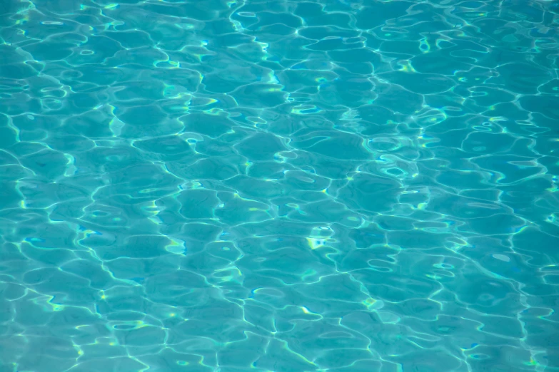 a body of water that is blue with ripples on it