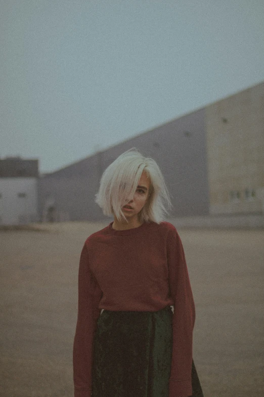 woman with white hair and blond wearing a red sweater