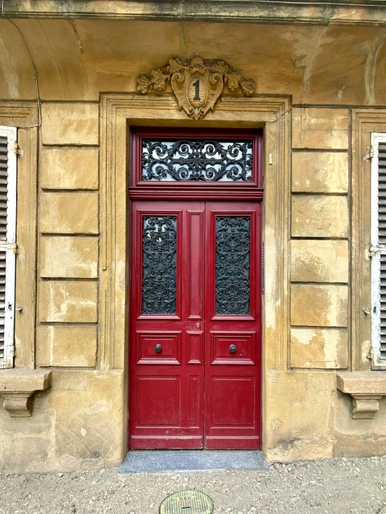 two doors sitting side by side in front of an old building