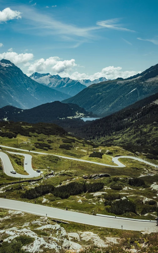 the curve of a road surrounded by mountains