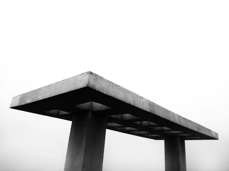 a large bridge is under a very cloudy sky