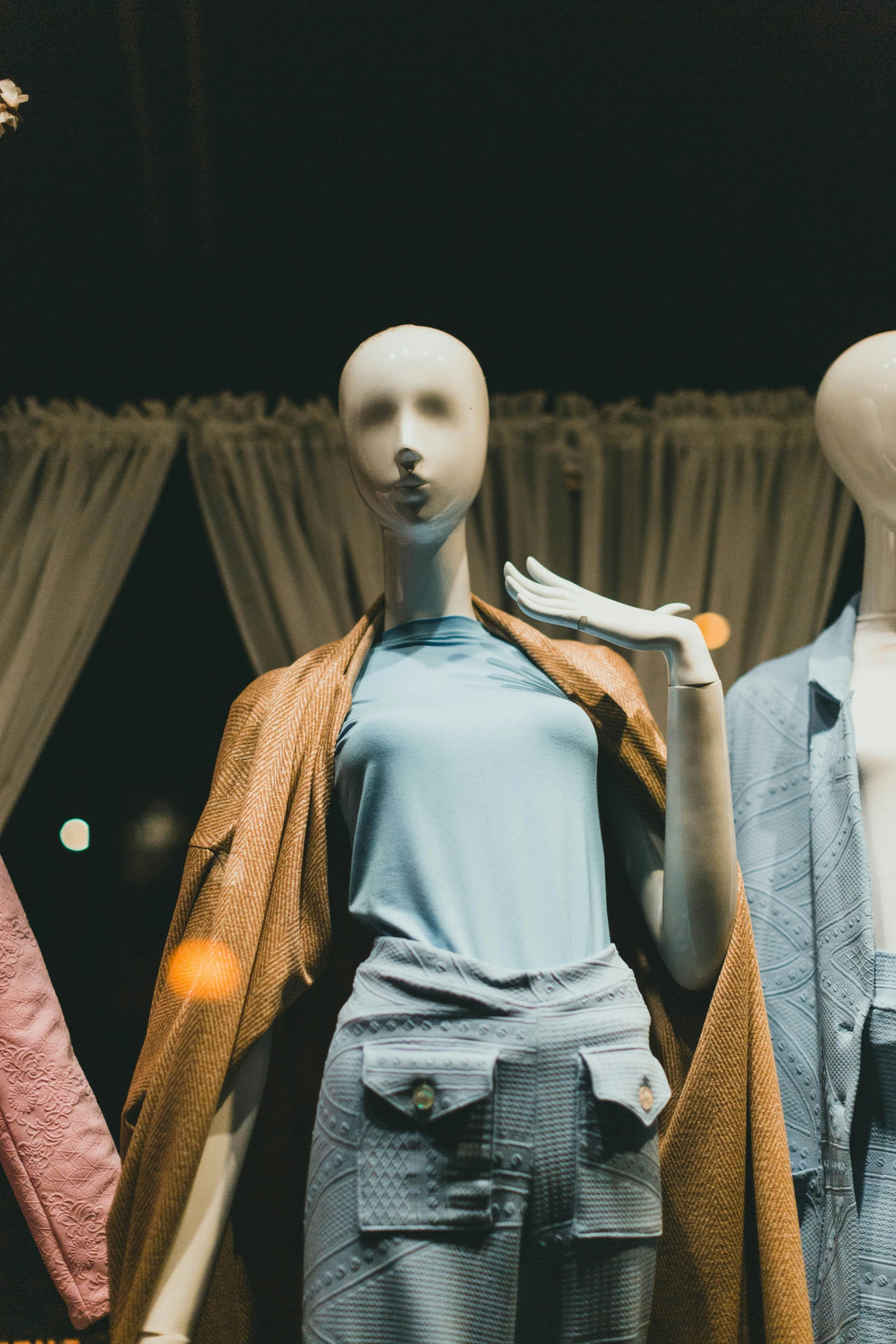 mannequins displaying shirts and jackets on display