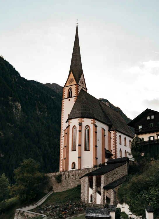 an image of a church building with mountains in the background