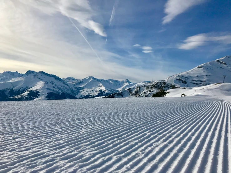 a wide and snowy landscape in the mountains