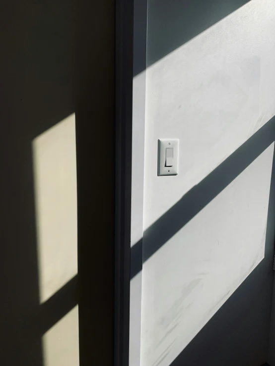 a white door with the light from a window in the background