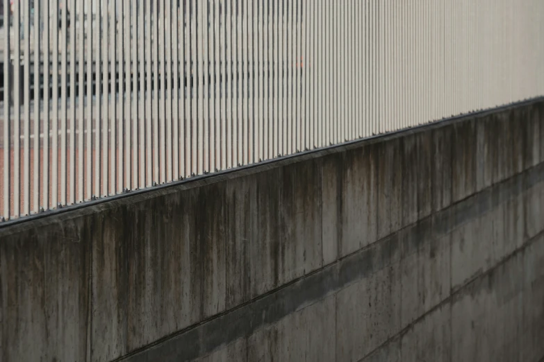 a man with a cell phone against a wall