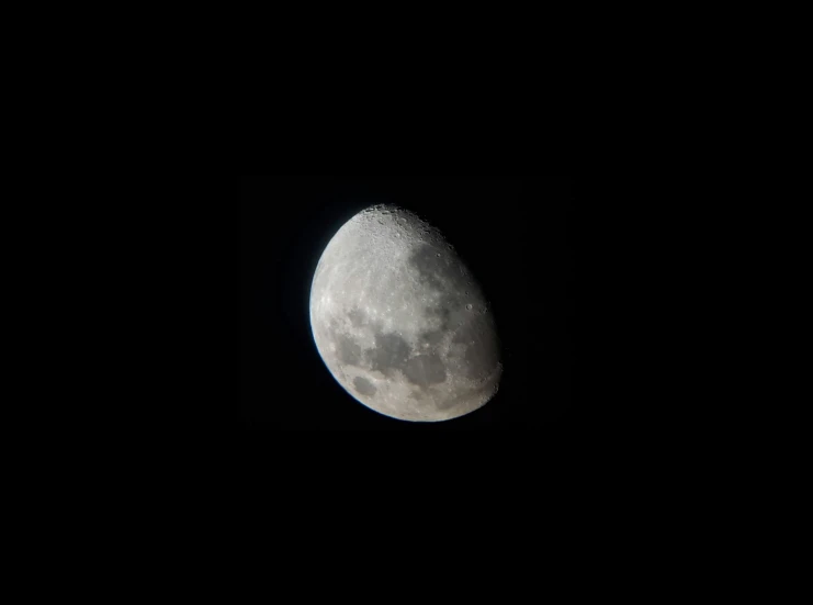 a large moon in the dark sky above