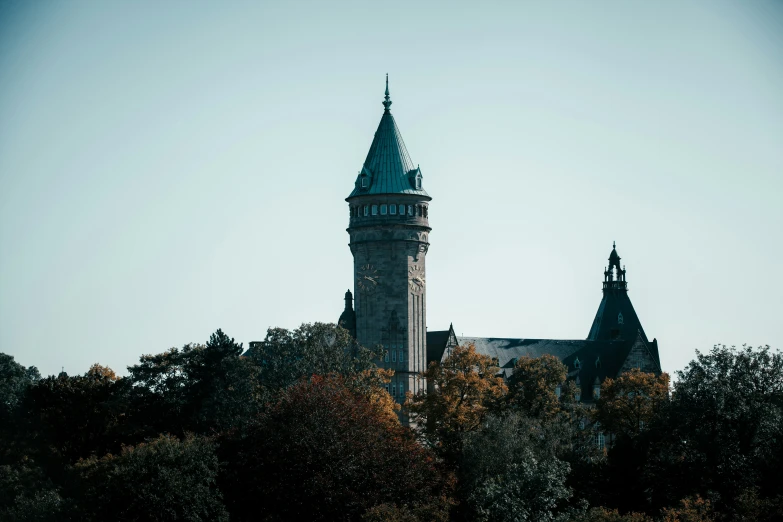 a tall clock tower with many steeples in the background