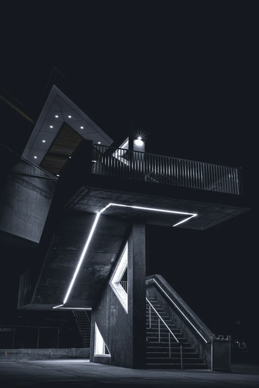 a very tall tower sitting above a staircase at night