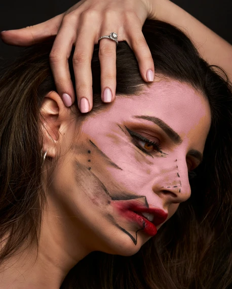a woman with face makeup and make up poses