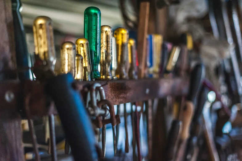 several vintage, metal and wood instruments sitting on a shelf