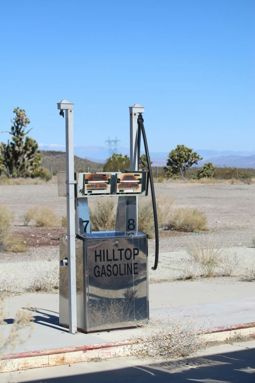 an old gas pump with a back load sitting on the side of the road