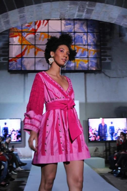 a model wears an unusual looking pink outfit