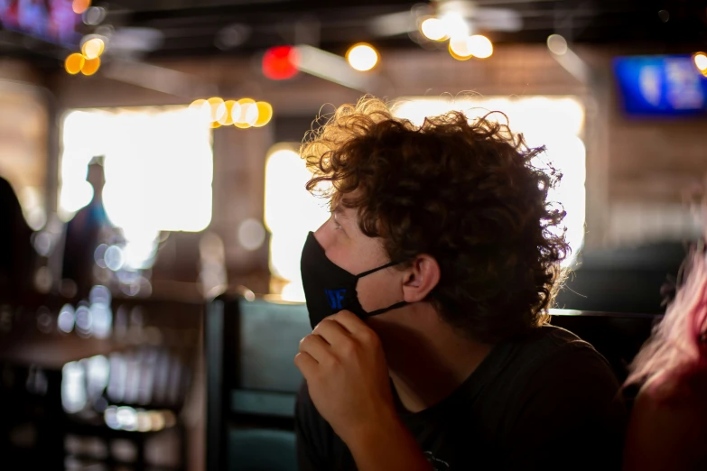 a young man wearing glasses sitting at a table