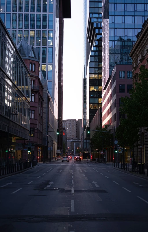 a street with two traffic lights next to tall buildings