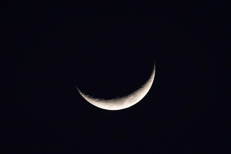 the half moon is seen in the sky above it