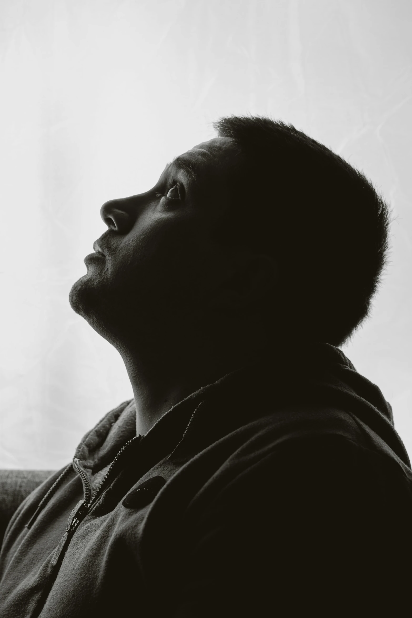 black and white pograph of a man looking up into the sky