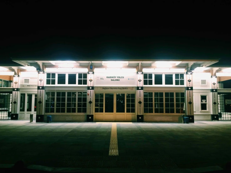 an empty building is lit up by lanterns at night