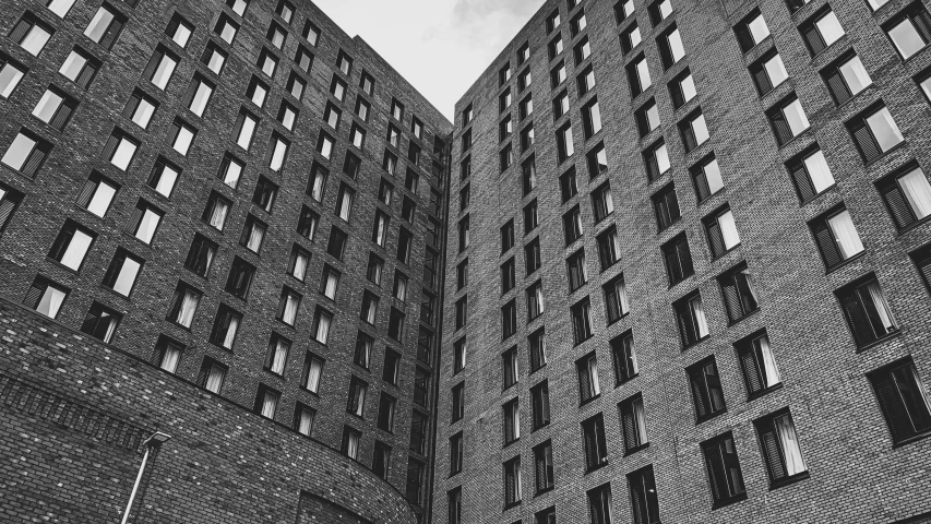 black and white pograph of two large brick buildings