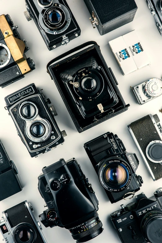 several different types of old cameras all lined up