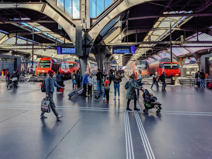 people are standing in a train station with luggage