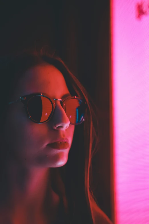 a woman wearing a pair of sunglasses is looking out of the window