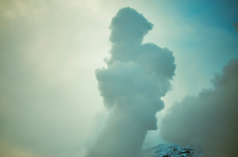 the smoke billows from a pipe that is pouring from the top