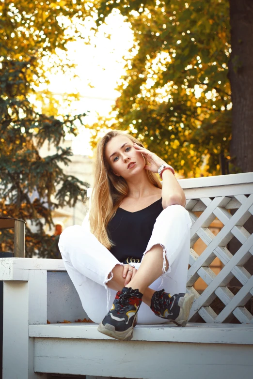 the woman sitting on the bench poses for the camera