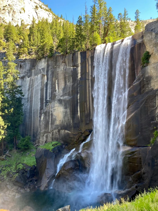 a waterfall, partially submerged by water from a river