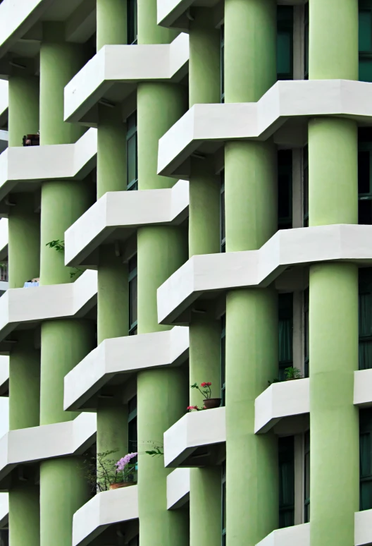 a building with very large windows is shown in front of a plant