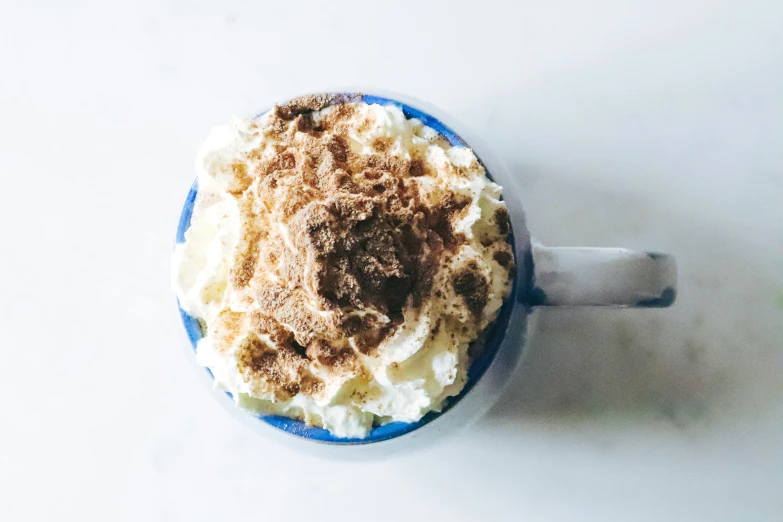 a dessert topped with whipped cream and sprinkled nuts